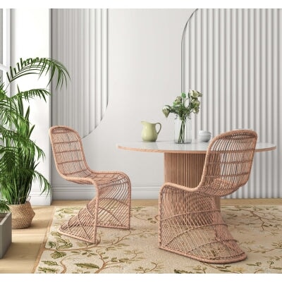 Groovy Rattan Dining Chair - styled with a round dining table and plants
