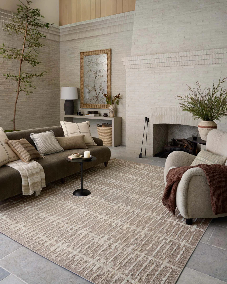 Amber Lewis × Loloi Bexley Rug in Taupe/Natural - styled with a sofa and accent chair