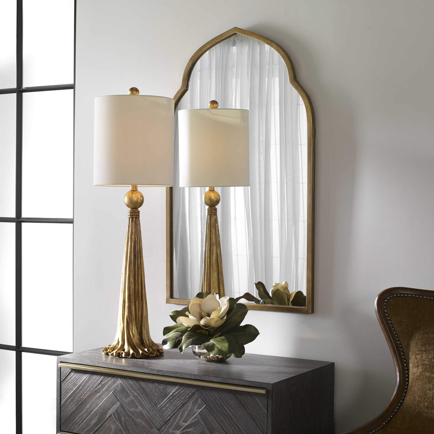 Kenitra arch mirror in gold styled with a lamp