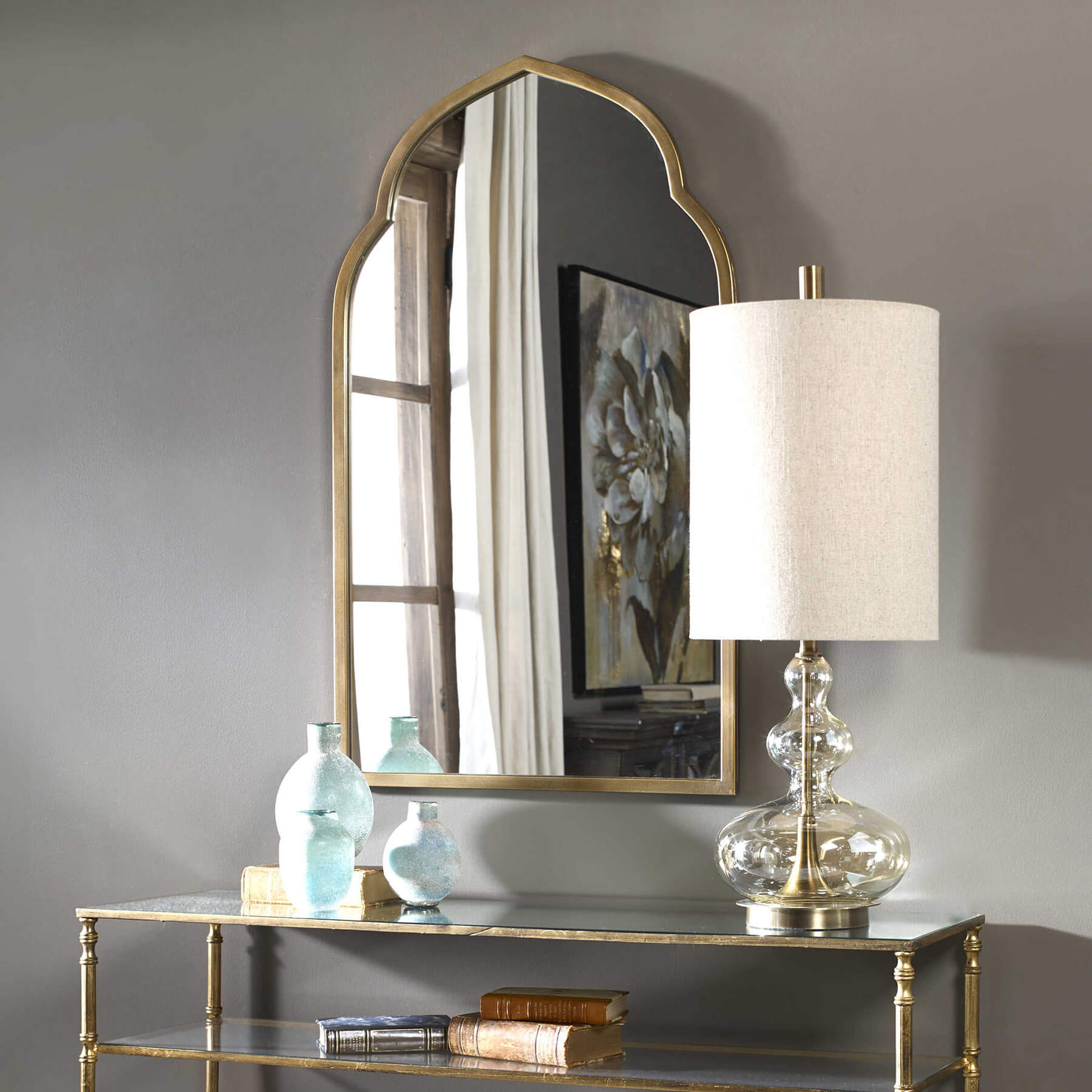 Kenitra arch mirror in gold styled with a console table