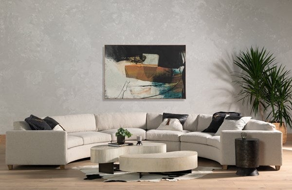 Avett Coffee Table from Four Hands in bleached guanacaste - styled with a large, semi circle sofa