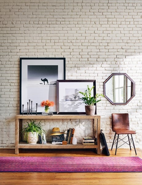 Lamar Console Table from Four Hands - styled with artwork as an entryway table