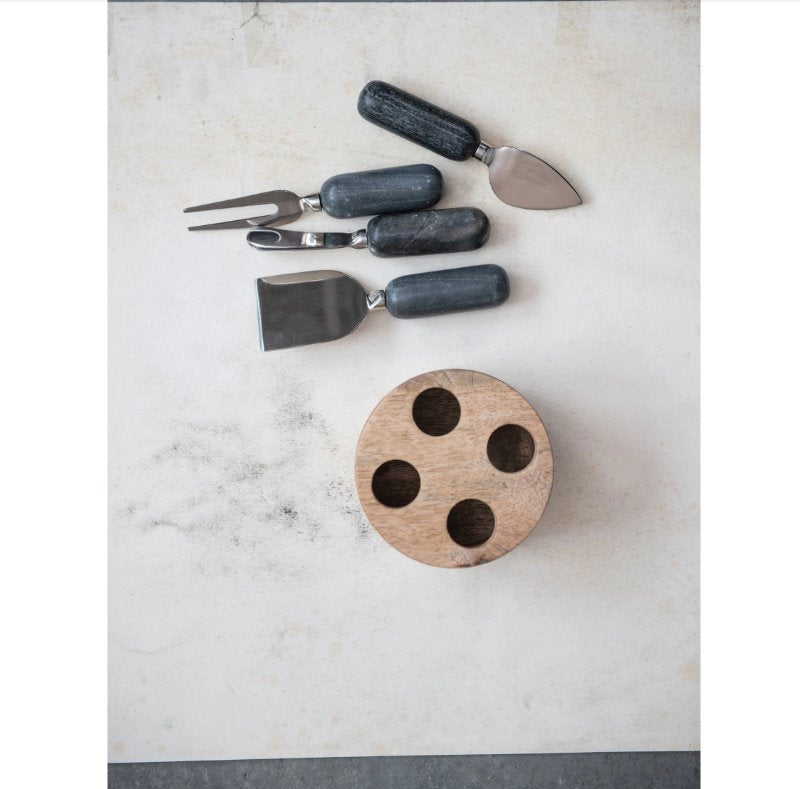 Wood Stand Stainless Steal Cheese Marble Servers: The ultimate serving utensils to use for your beautifully crafted cheese board. This light round mango wood stand holds four different servers with a black marble handle for different assortment of cheeses.