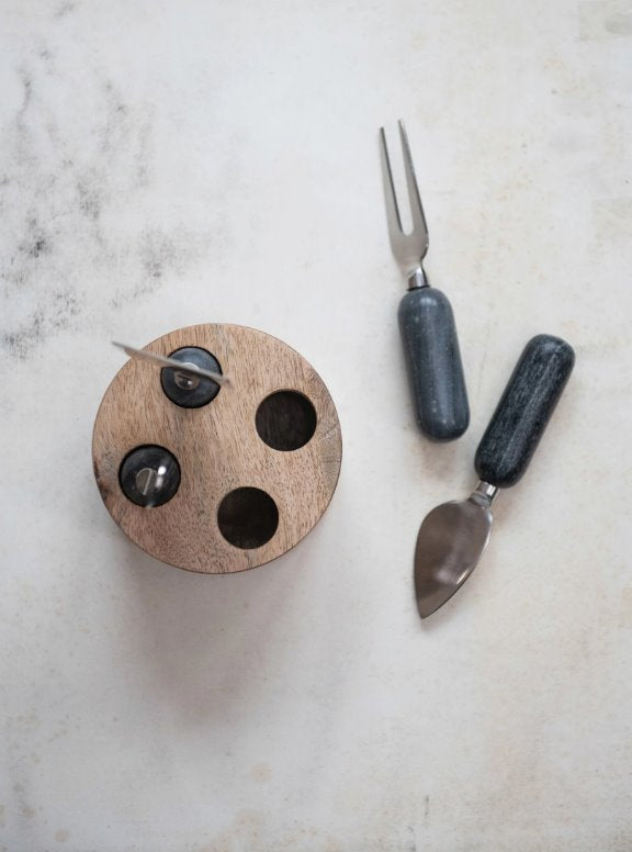 Wood Stand Stainless Steal Cheese Marble Servers: The ultimate serving utensils to use for your beautifully crafted cheese board. This light round mango wood stand holds four different servers with a black marble handle for different assortment of cheeses.