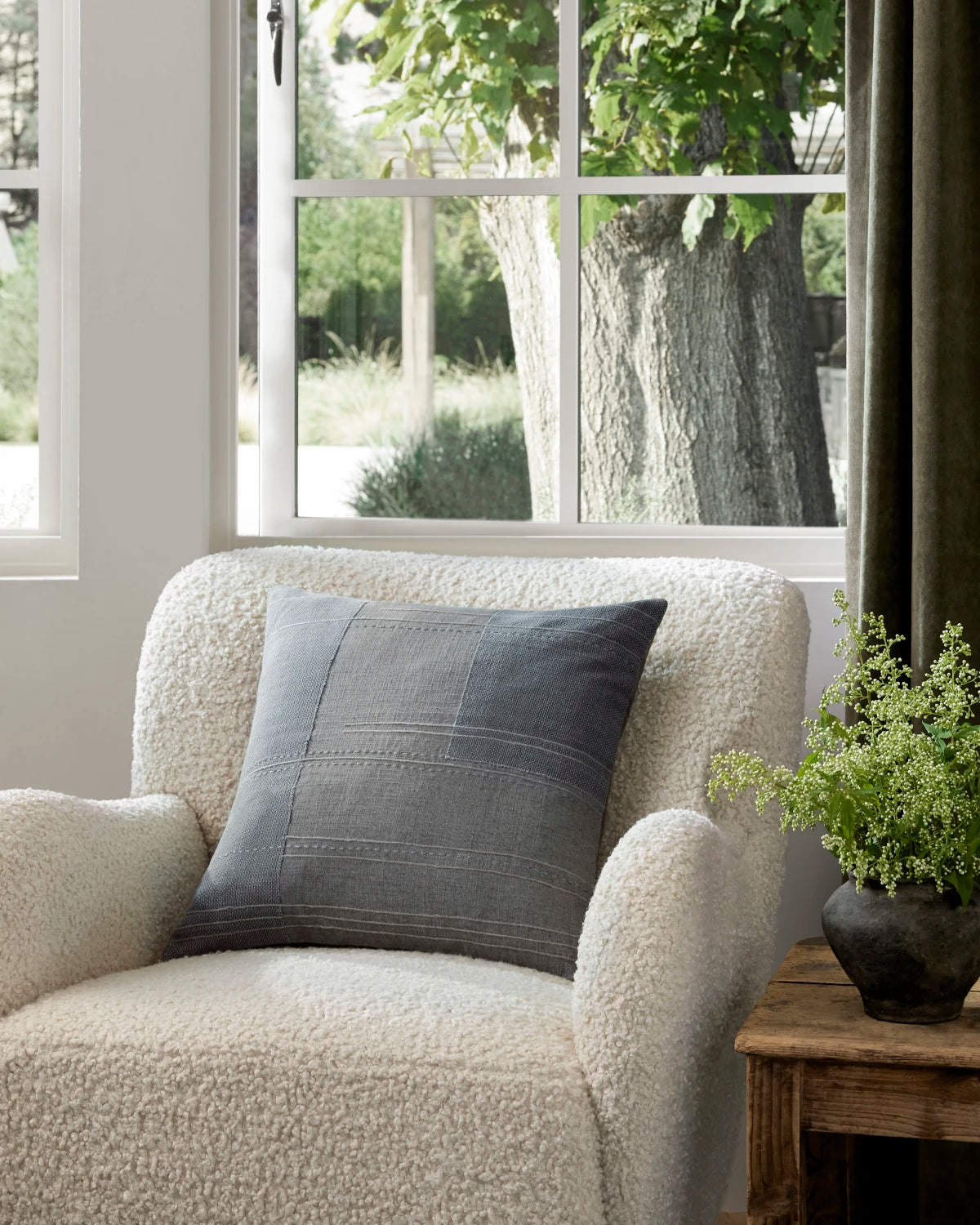 Amber Lewis × Loloi Mateo Pillow - styled on a boucle chair