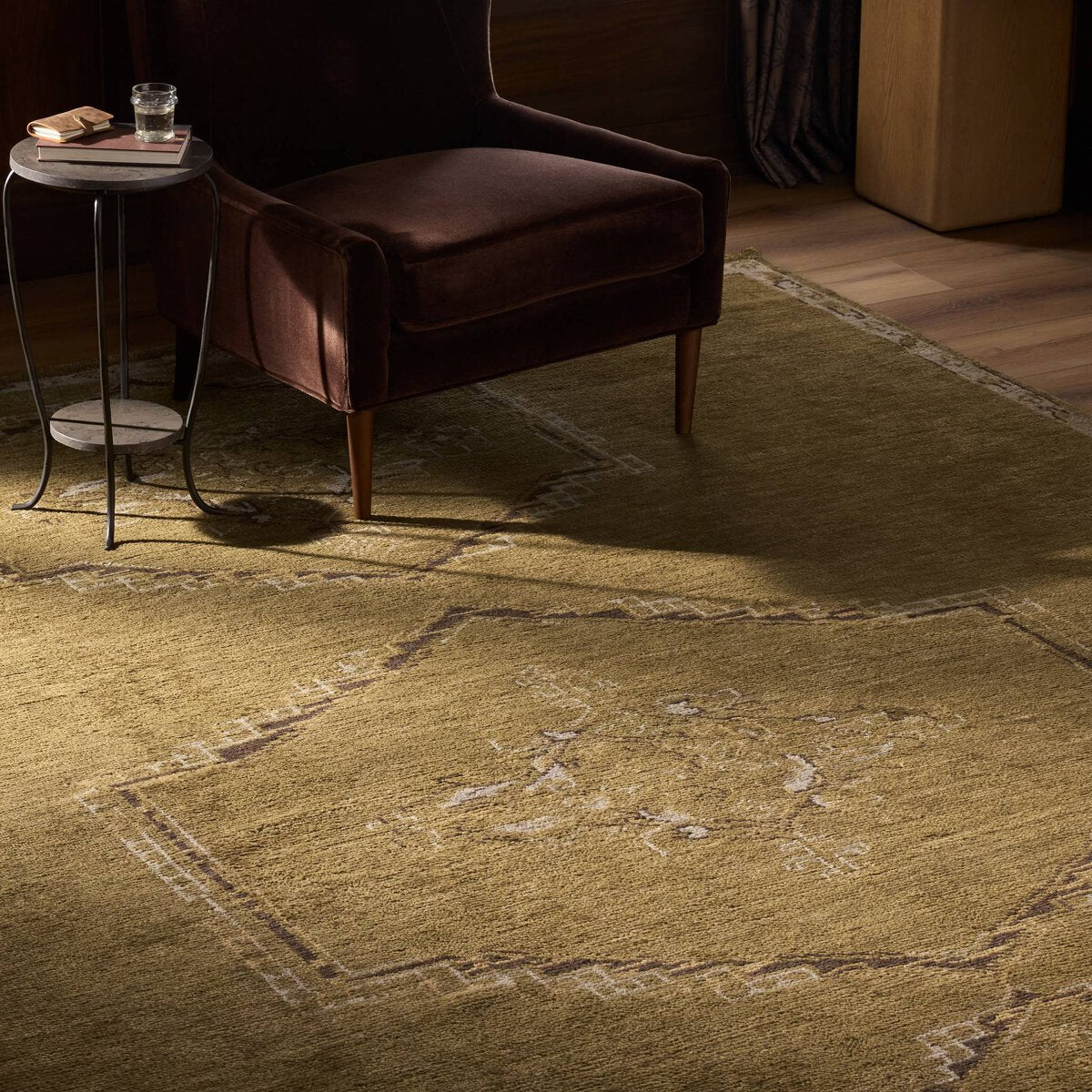 Astana Hand Knotted Rug - shown styled with a velvet chair and drink table