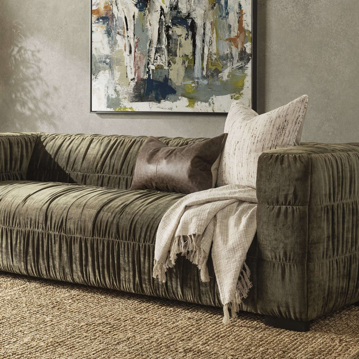 Afeela Sofa - styled with a leather pillow and woven throw