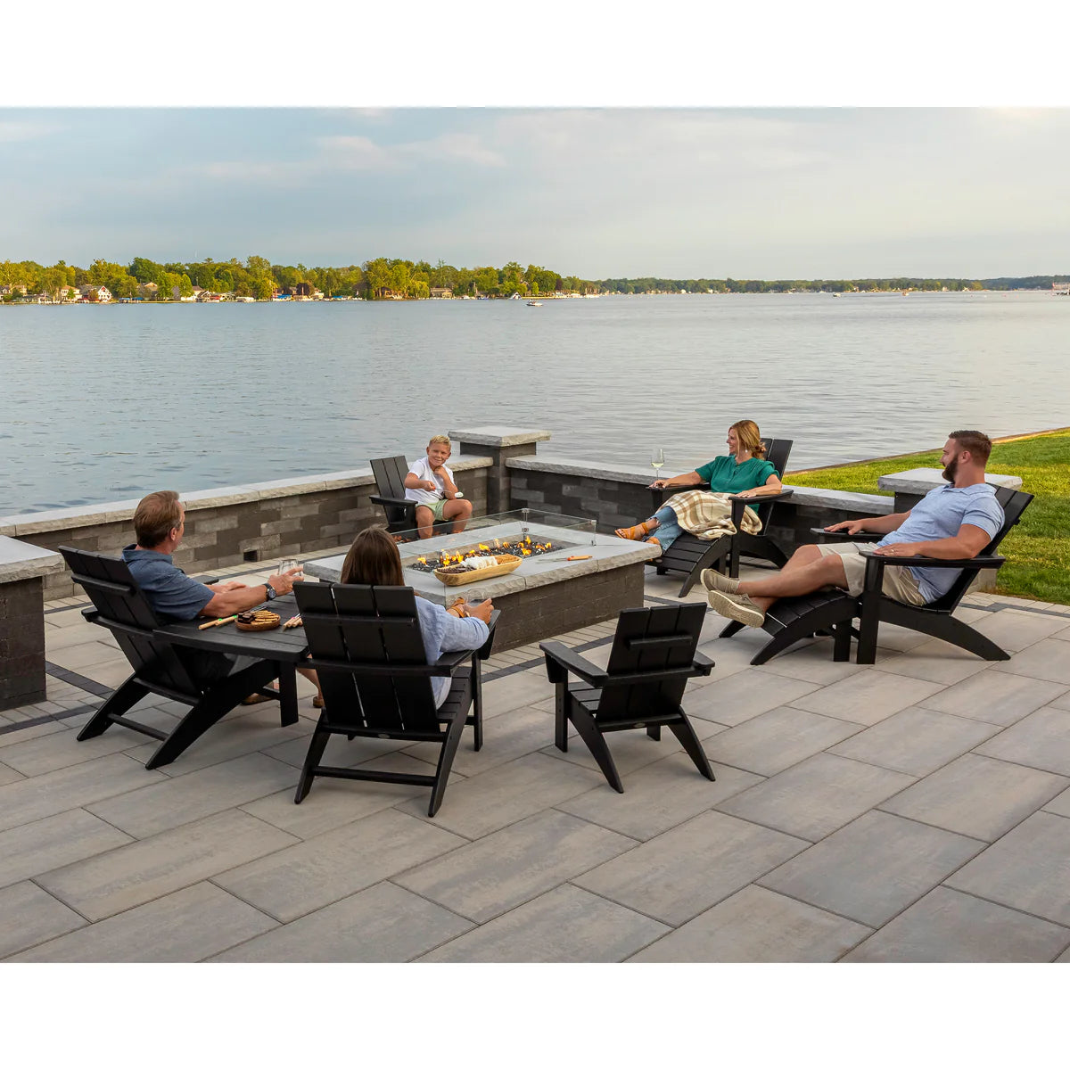 Modern Adirondack Chair - a family enjoys lounging in chairs arranged by a firepit