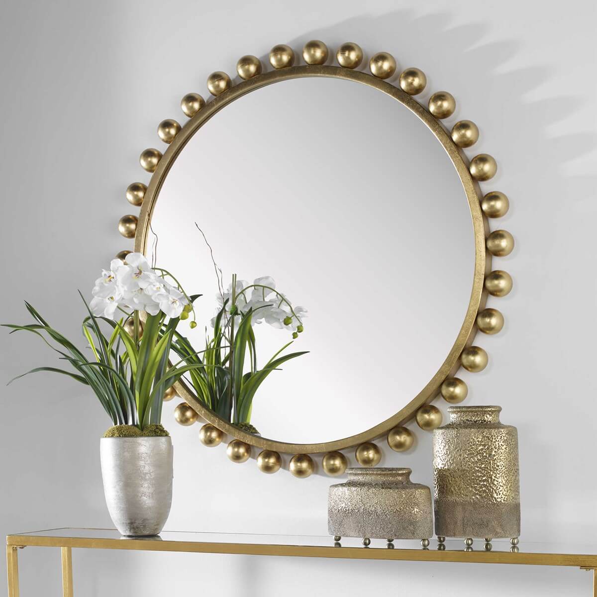 Cyra mirror in gold styled with flowers and candles