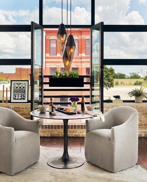 Simone Bistro Table - styled with upholstered side chairs in an upscale loft