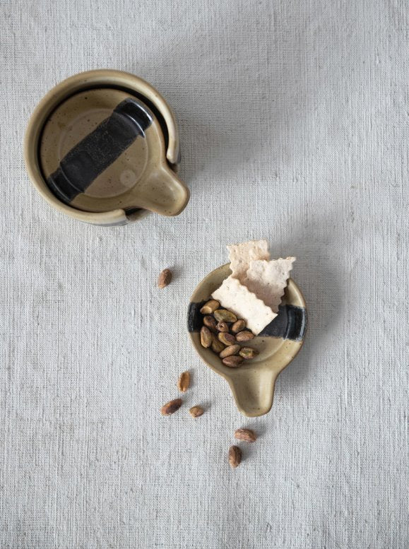 Tapa Plates w/ Holder: When decorative and functional meet! Black and brown spectacled reactive glaze ceramic plates w/ holder to beautifully display appetizers and snacks. This holder stores four mini circular plates with a handle so it is easier for you and your guests to move around while snacking.