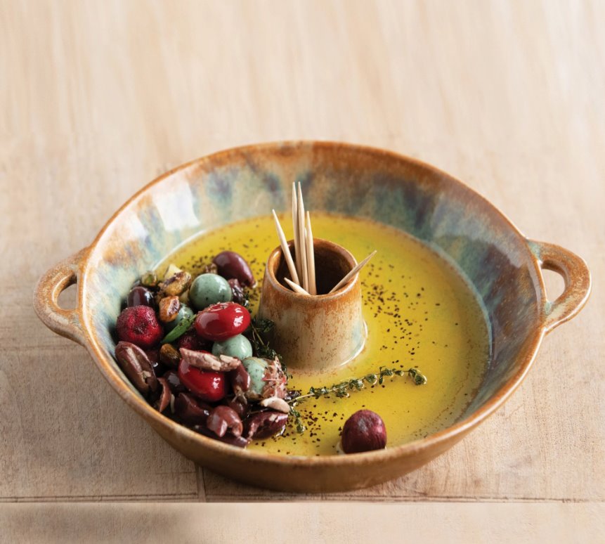 Stoneware Toothpick Holder: This dish is perfect for the person who loves to throw dinner parties. A lovely circular brown container with side handles that has a toothpick holder in the center;  making the reactive glaze stoneware functional for serving small finger foods at your next party!