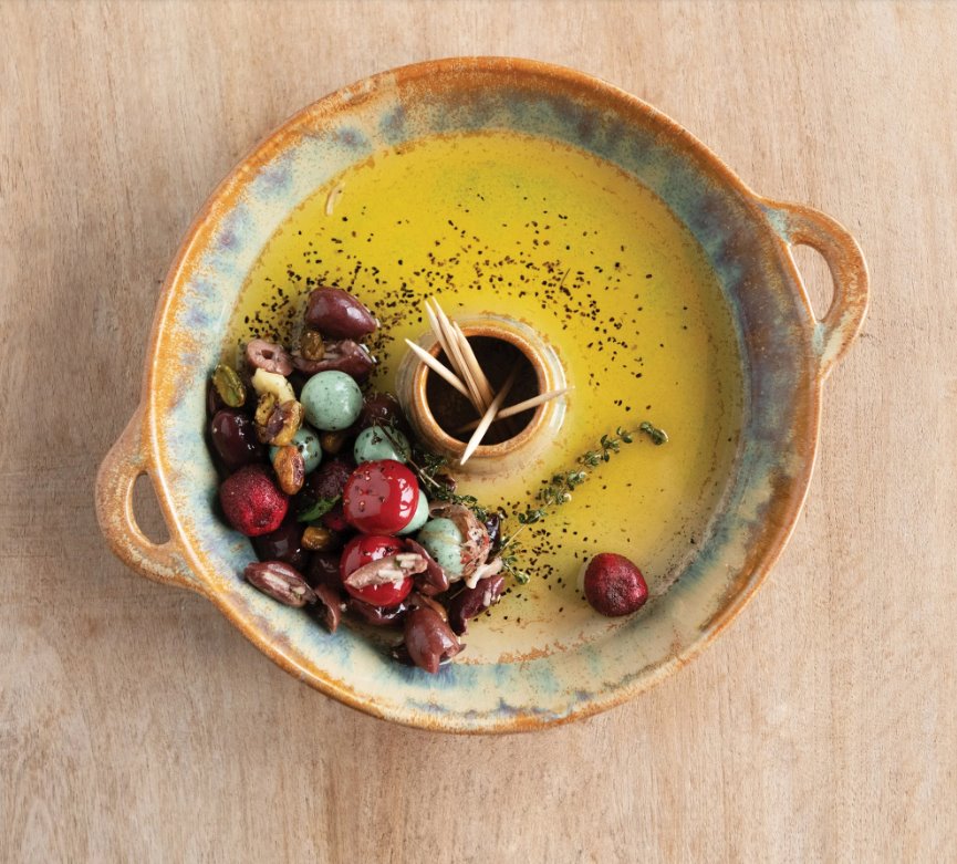 Stoneware Toothpick Holder: This dish is perfect for the person who loves to throw dinner parties. A lovely circular brown container with side handles that has a toothpick holder in the center;  making the reactive glaze stoneware functional for serving small finger foods at your next party!