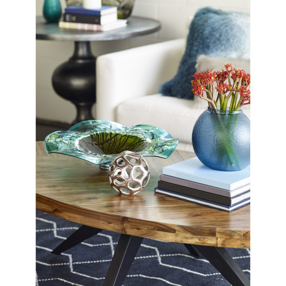 Parq Oval Coffee Table styled with vignette of decorative objects